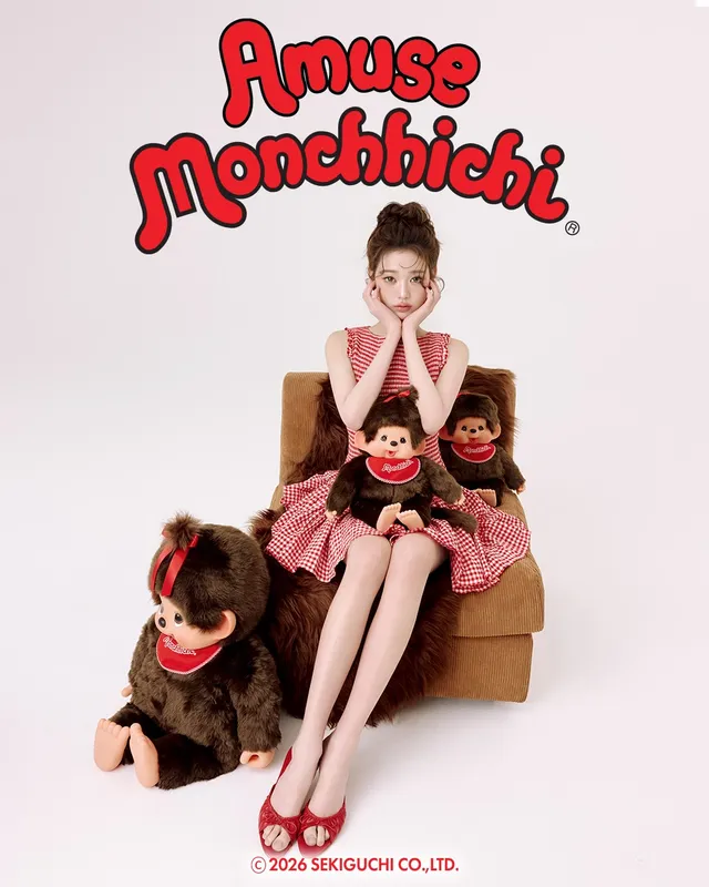 Jang Wonyoung sitting in a chair in a pink outfit and red heels.