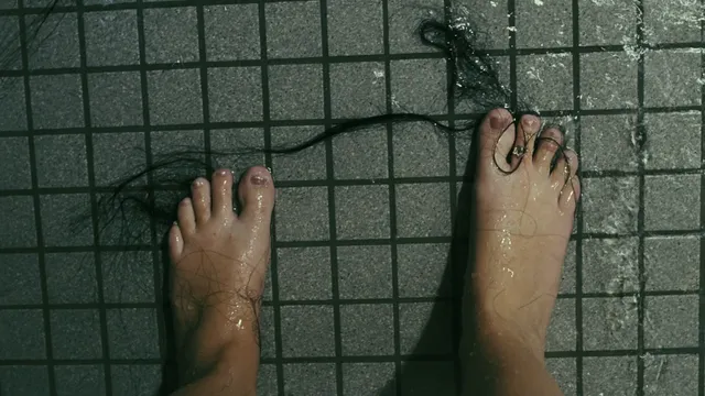 Teresa Palmer a close-up of wet bare feet on tiles.