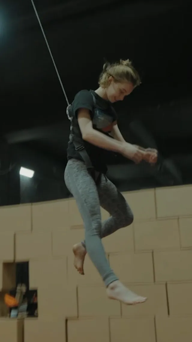 Emma Myers jumping barefoot during a training session.