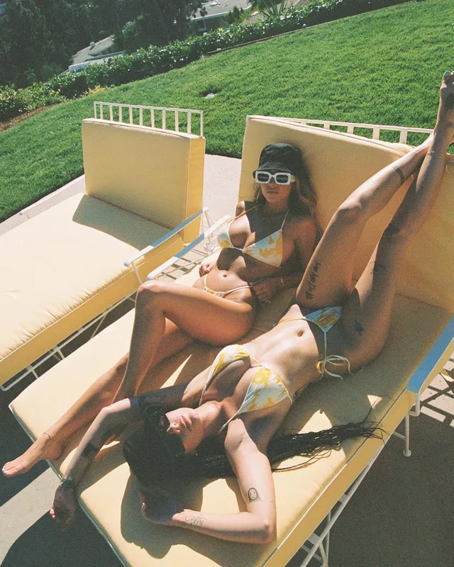 Halsey a relaxed poolside photograph on a sunbed.