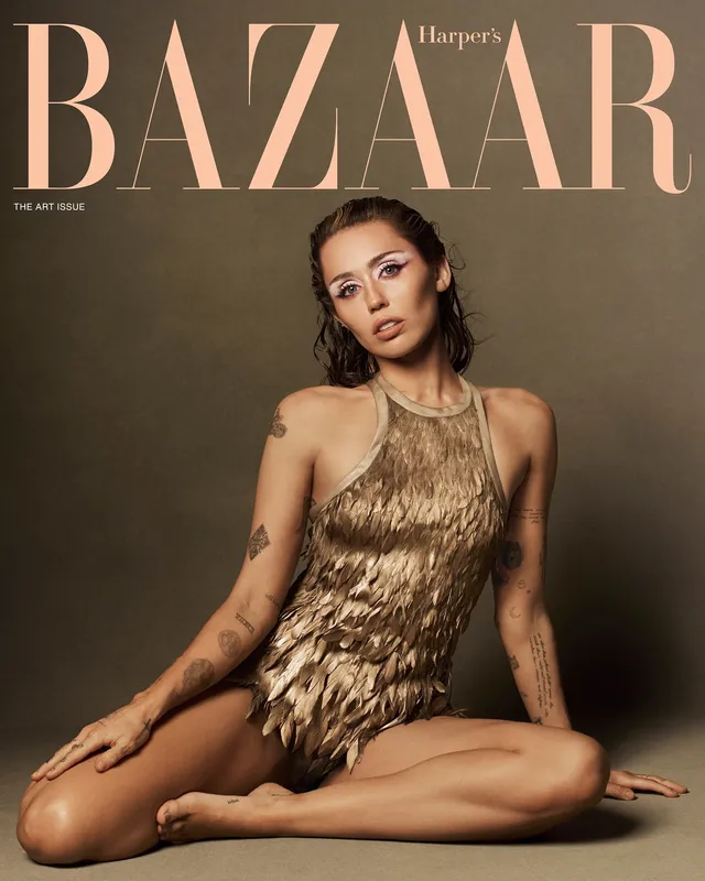Miley Cyrus sitting barefoot for a magazine portrait.