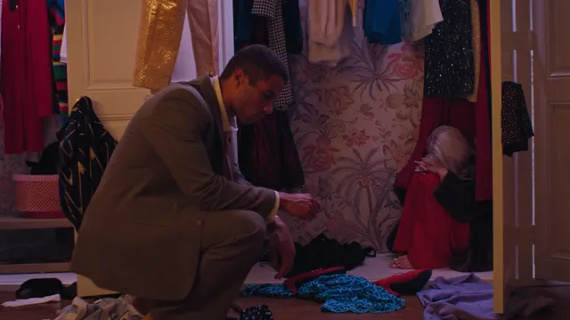 Ariel Winter sitting during a screen scene in a bedroom.