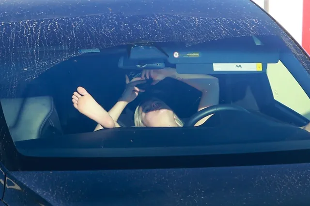 Ariel Winter resting her bare feet inside a car.