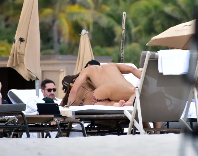 Jessica Alba reclining barefoot on a sun lounger.