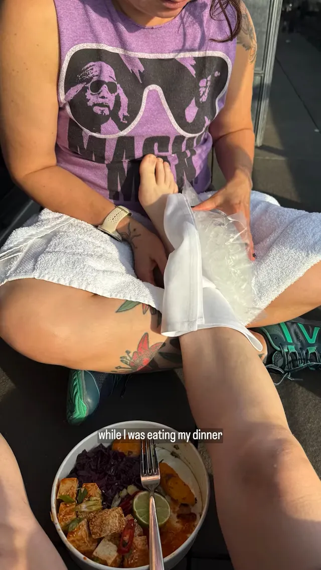 Billie Eilish a seated backstage photograph during an ankle treatment.