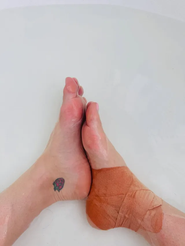 Katy Perry showing tattooed bare soles in a close-up.