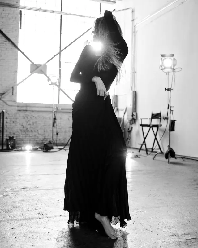Angelina Jolie a standing monochrome portrait in a black gown.