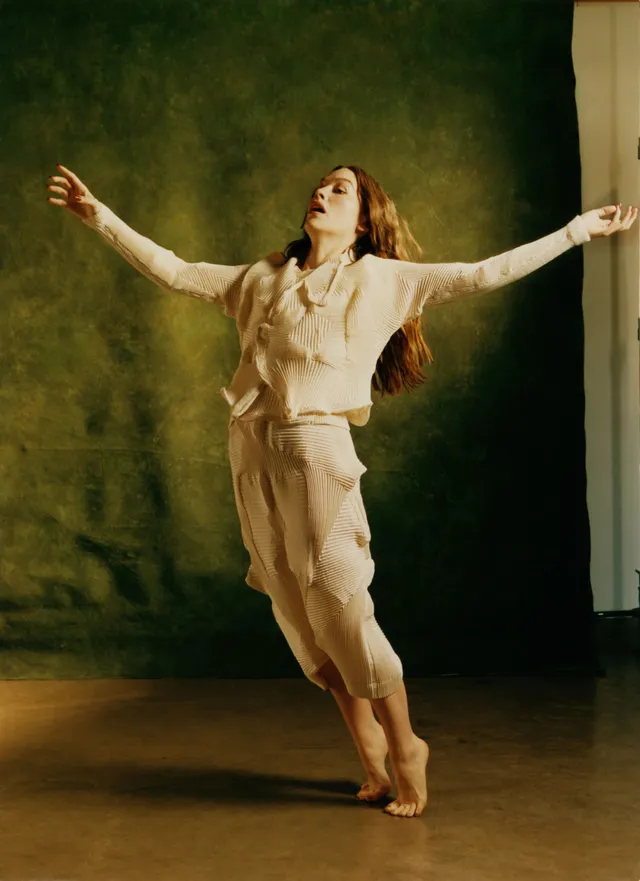 Victoria Pedretti posing for a studio portrait in a pale outfit.