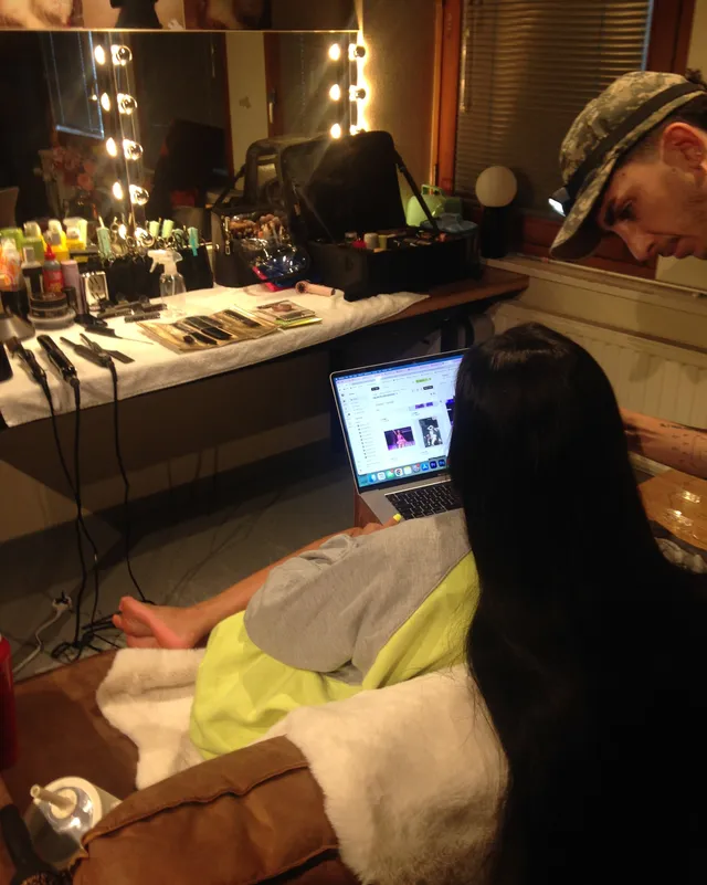 Tyla resting her bare feet beside a dressing table during preparation.
