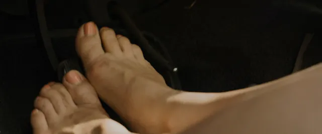 Florence Pugh a screen detail of bare feet resting together.