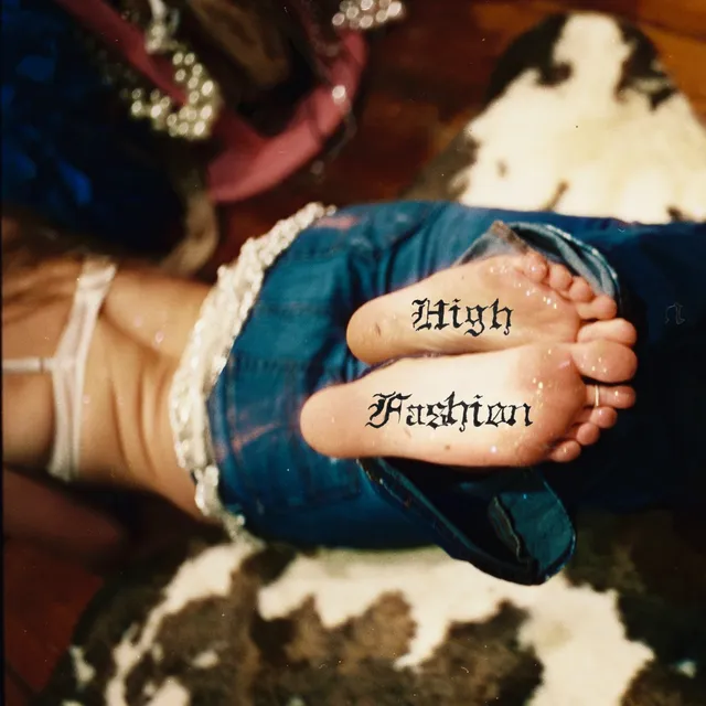 Addison Rae showing bare soles with decorative lettering.