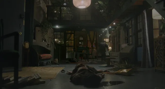 Zoë Kravitz lying in a furnished room in a screen scene.