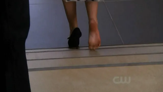 Leighton Meester stepping along a corridor during a screen scene.