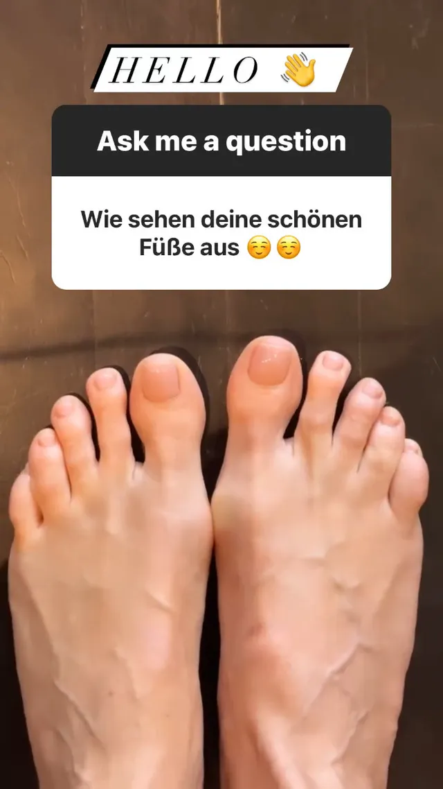 Heidi Klum resting her bare feet on a wooden floor.