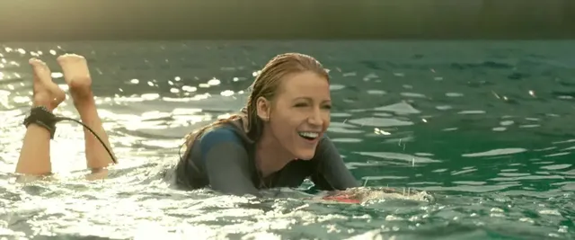 Blake Lively floating in water with bare soles raised in a screen scene.