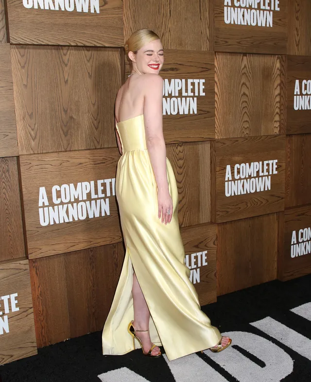 Elle Fanning wearing a pale yellow gown at a film event.