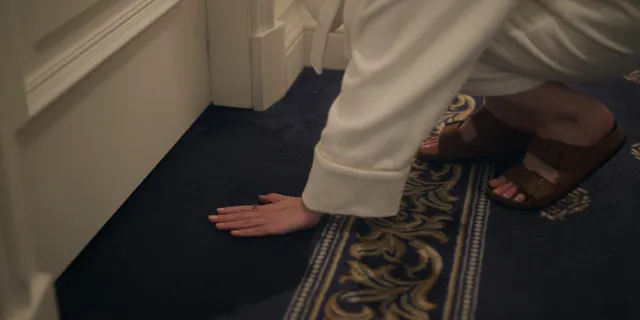 Anna Kendrick photo collection: a close-up of a hand beside a patterned floor.