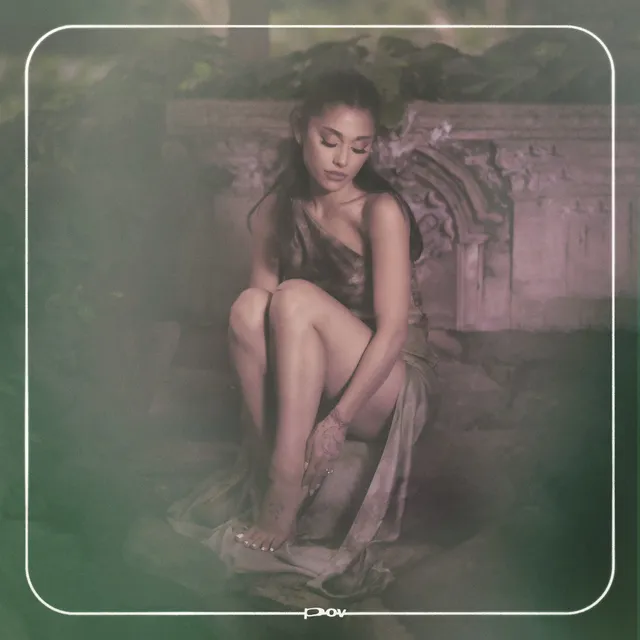 Ariana Grande: crouching outdoors wearing high heels.