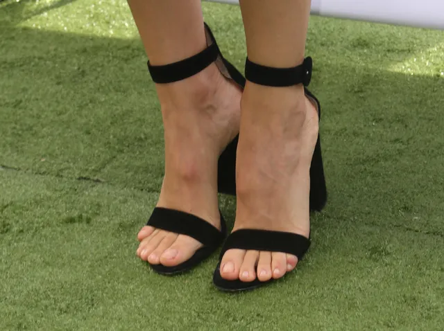 Jennifer Garner a close-up of black block-heel sandals.