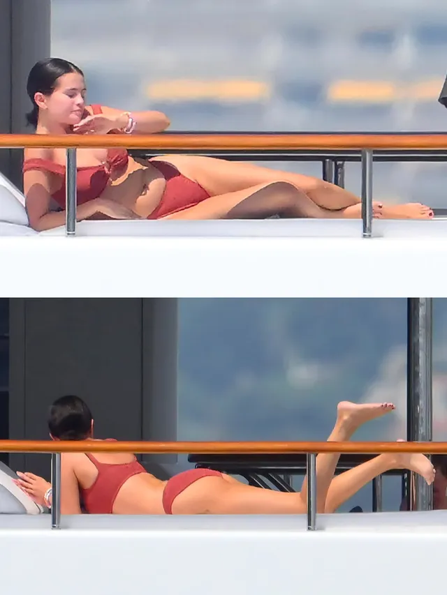 Selena Gomez reclining on a boat in a red swimsuit.