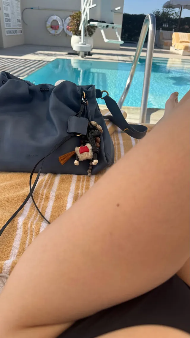 Adelaide Kane a casual view of a bare leg beside a pool.