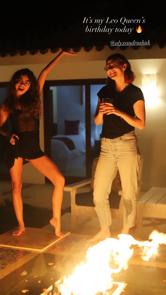 Sarah Hyland dancing with companions indoors.