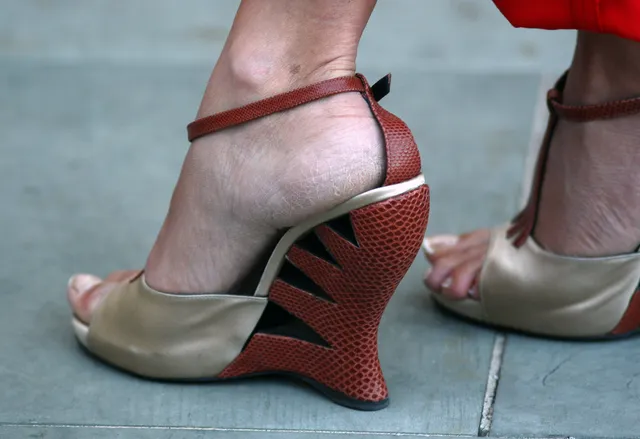 Penélope Cruz a close rear detail of sculptural metallic heels.