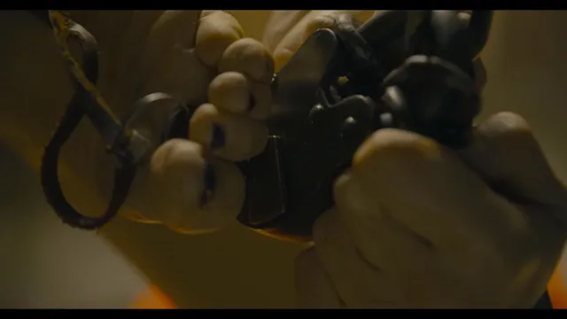 Margot Robbie in a cropped film still showing bare soles and footwear.