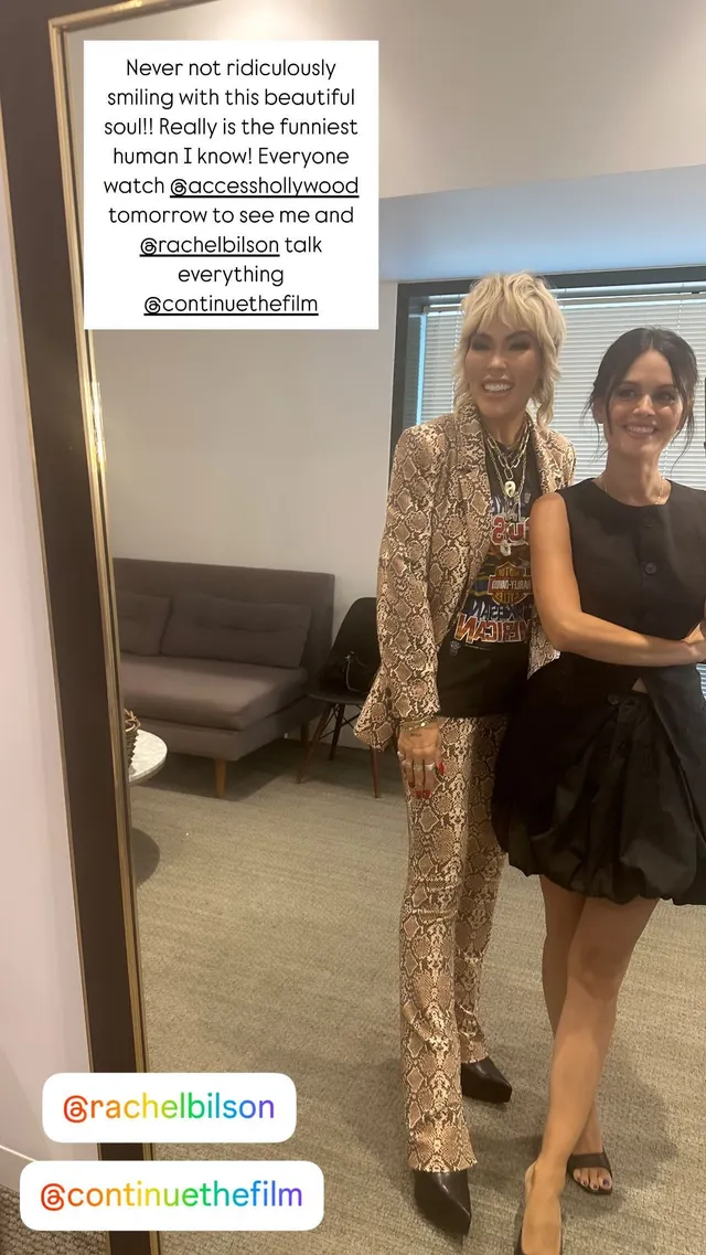 Rachel Bilson posing with a companion for a mirror portrait.