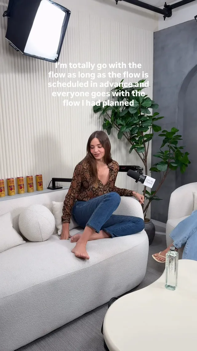 Miranda Kerr a casual barefoot portrait on a sofa.
