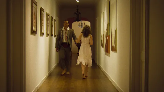 Odessa A'zion walking barefoot through a hallway in a scene.