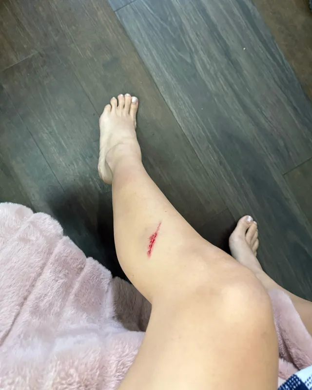 Lisa (Lalisa Manobal) showing her bare legs and feet while resting indoors.