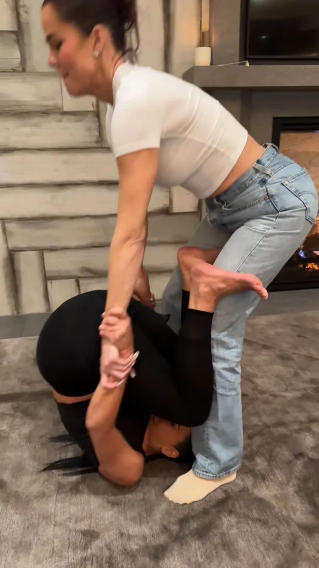 Kim Kardashian lying on a floor beside a companion.
