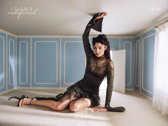 Hande Erçel wearing a black lace dress in a studio.