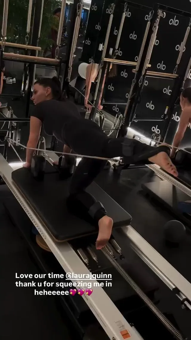 Dafne Keen exercising barefoot on a Pilates reformer.