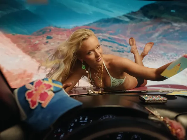 Zara Larsson lying on a surfboard with bare feet raised.
