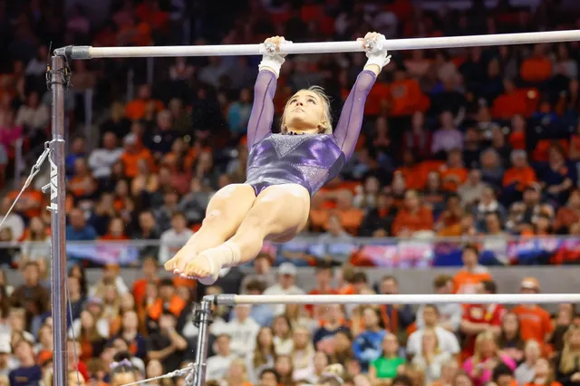 Olivia Dunne performing on uneven bars during a gymnastics competition.