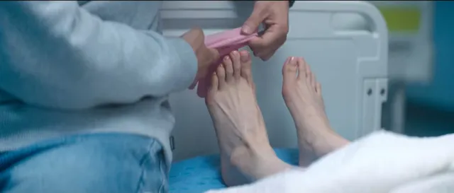 Bae Suzy having her bare toes attended to in a scene.