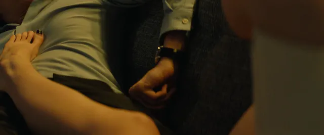 Anya Taylor-Joy resting a bare foot on a table in a screen scene.