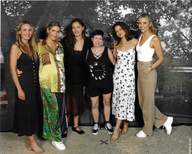 Danielle Campbell standing with companions during an event.