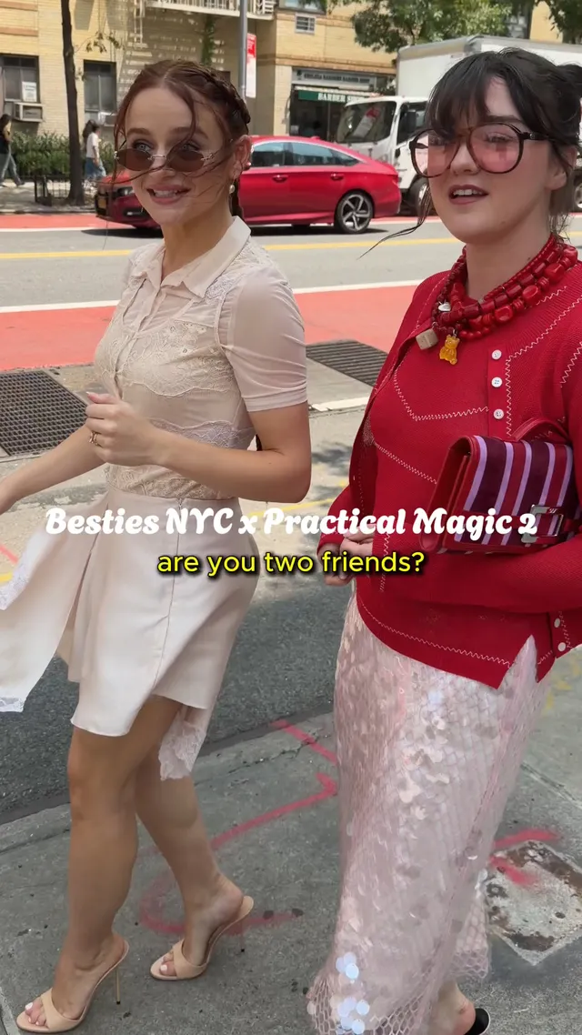 Joey King walking beside another woman in a pale dress and heels.