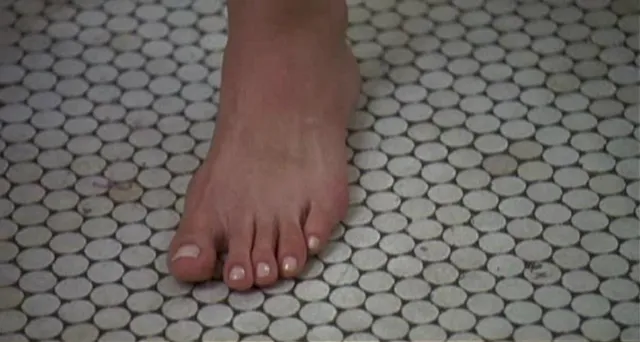 Sarah Michelle Gellar showing a bare foot on a tiled floor.