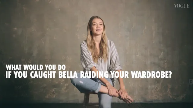 Gigi Hadid sitting with one bare foot raised during an interview.