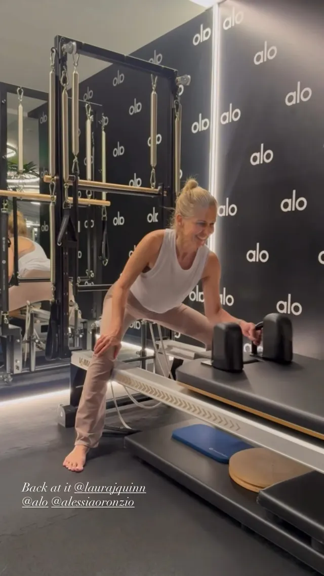 Sarah Michelle Gellar exercising on a reformer in a gym.