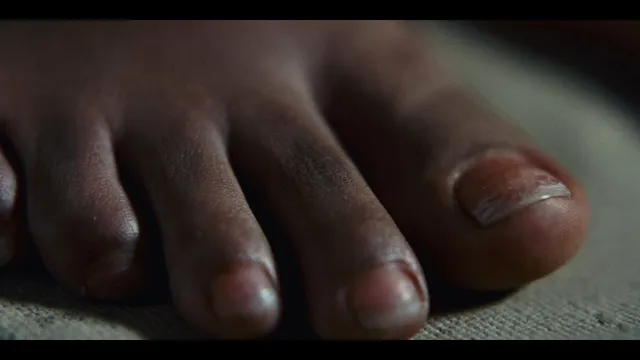 Sophie Wilde with bare toes visible in a close-up film scene.
