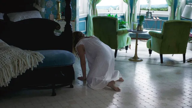 Amy Adams kneeling on the floor during a screen scene.