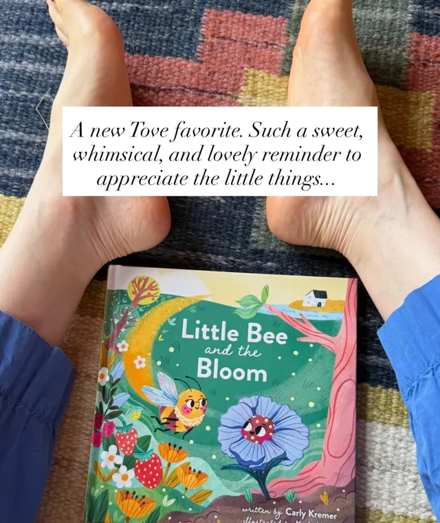 Lily Collins showing bare feet beside a book on a rug.