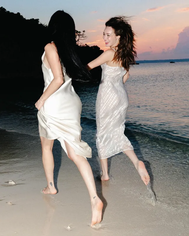 Alycia Debnam-Carey dancing with a companion beside the sea.