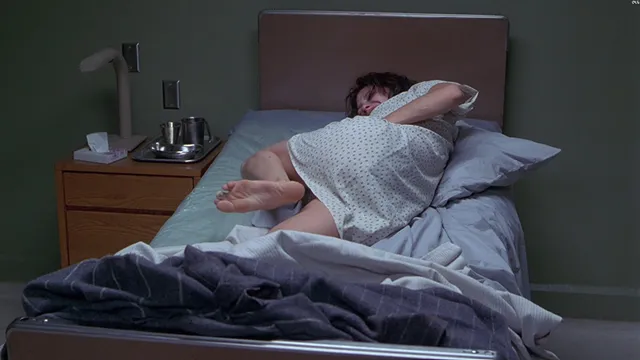 Angelina Jolie a reclining screen scene on a bed.