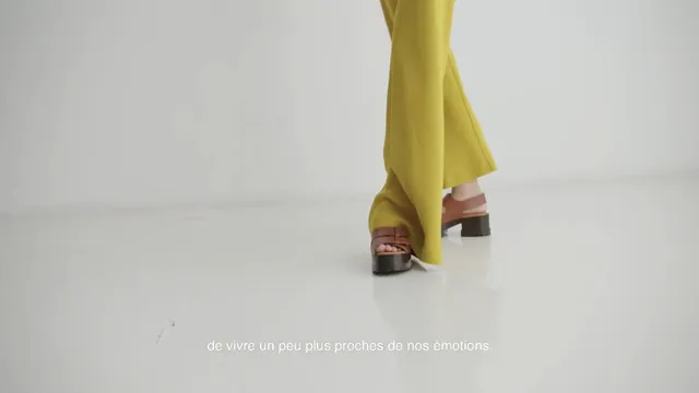 Havana Rose Liu wearing brown platform sandals beneath yellow trousers.